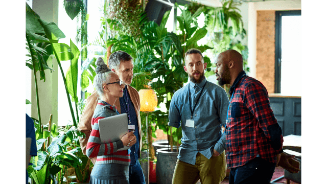 Mixed workers have a standup chat.