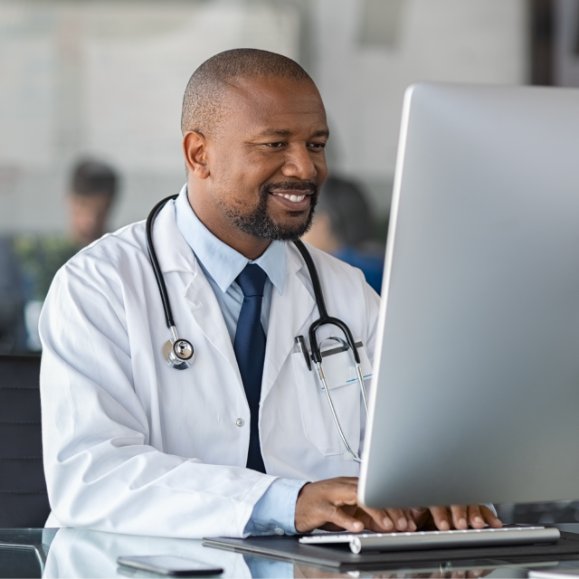 Male doctor using laptop