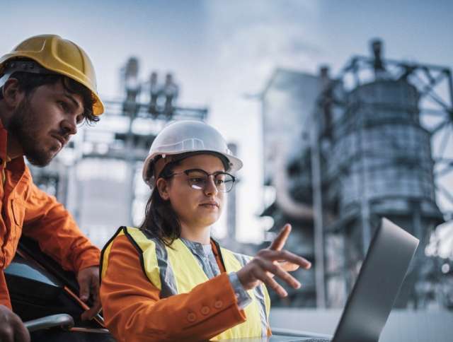 Energy workers looking at laptop