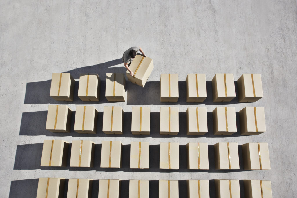 Man placing box into line