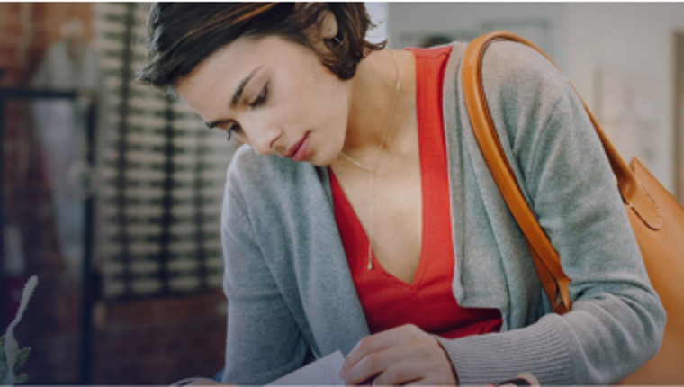 Young woman reading paperwork