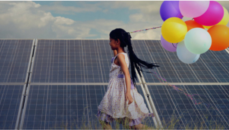 young girl holding balloons