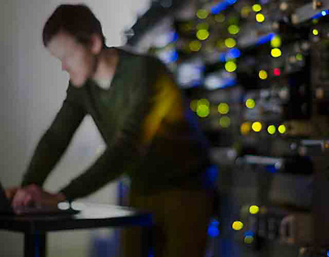 man working in a room with control panels