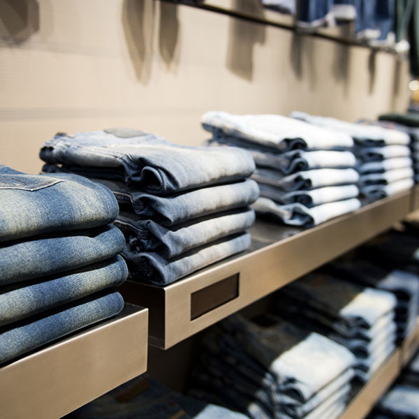 Different stacks of denim pants on display