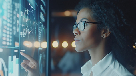 A woman operating a large touch screen