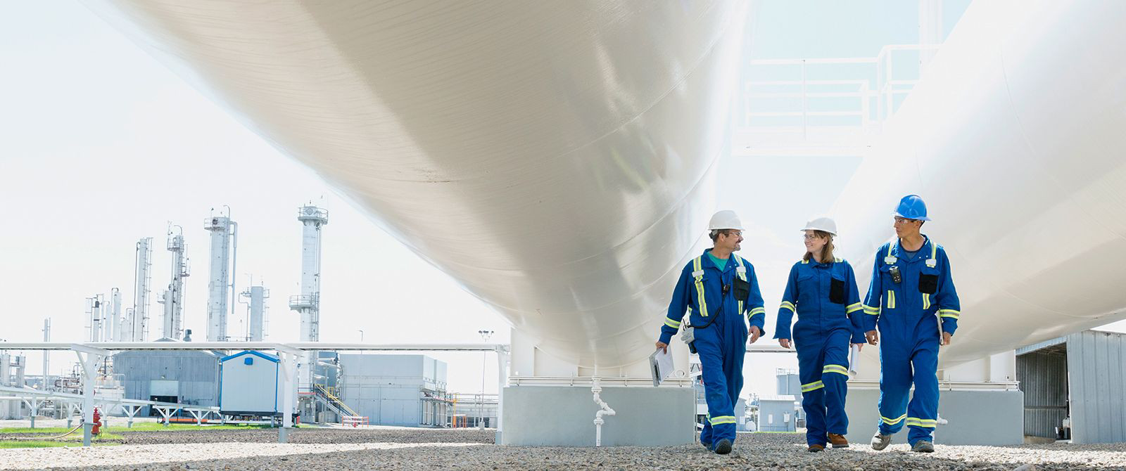 three factory workers walking together