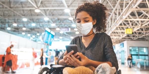 woman wearing a mask looking at phone