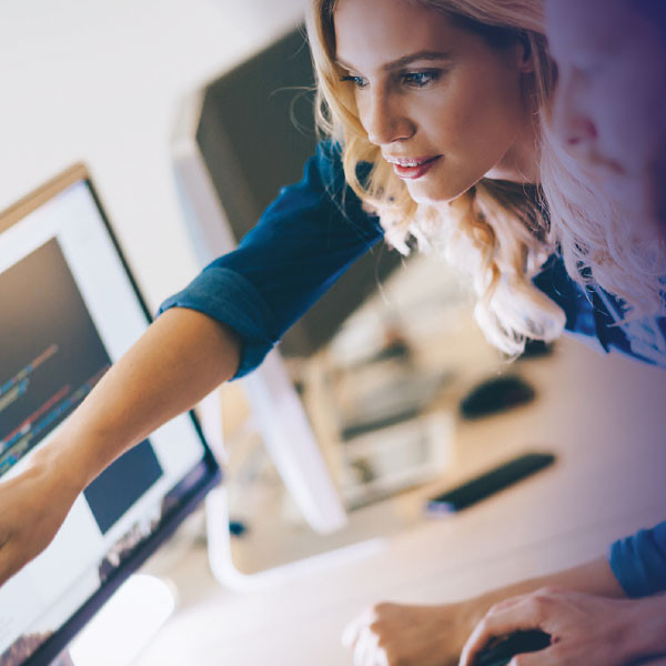 two people looking at computer screen