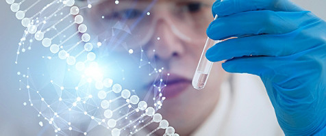 woman looking at a test tube with some liquid