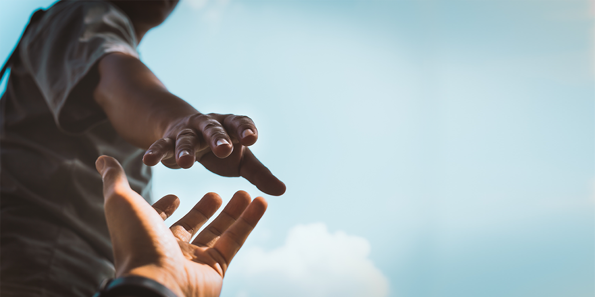 a person giving hand to another