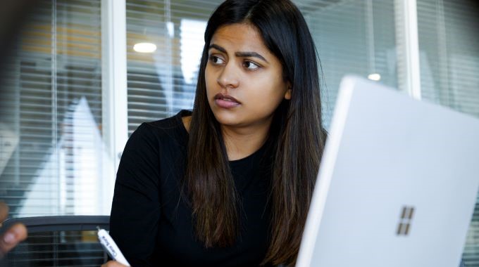 Woman taking notes during meeting