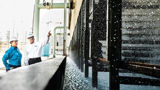 Ecolab associate on-site with a customer examining their water system 