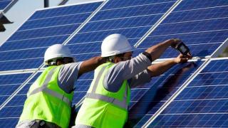 Two workers installing solar energy panels at the Leech Lake Indian Reservation