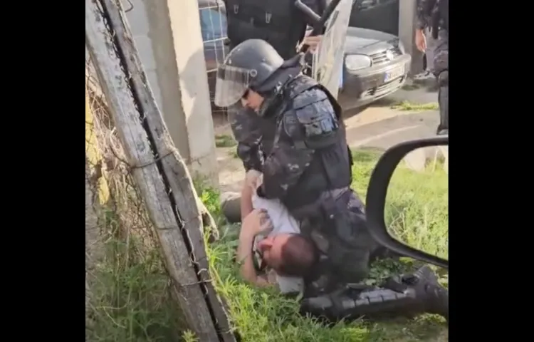 A police officer holds journalist Furkan Saliu down on the ground at a soccer game in Gorno Konjare in North Macedonia on April 7.