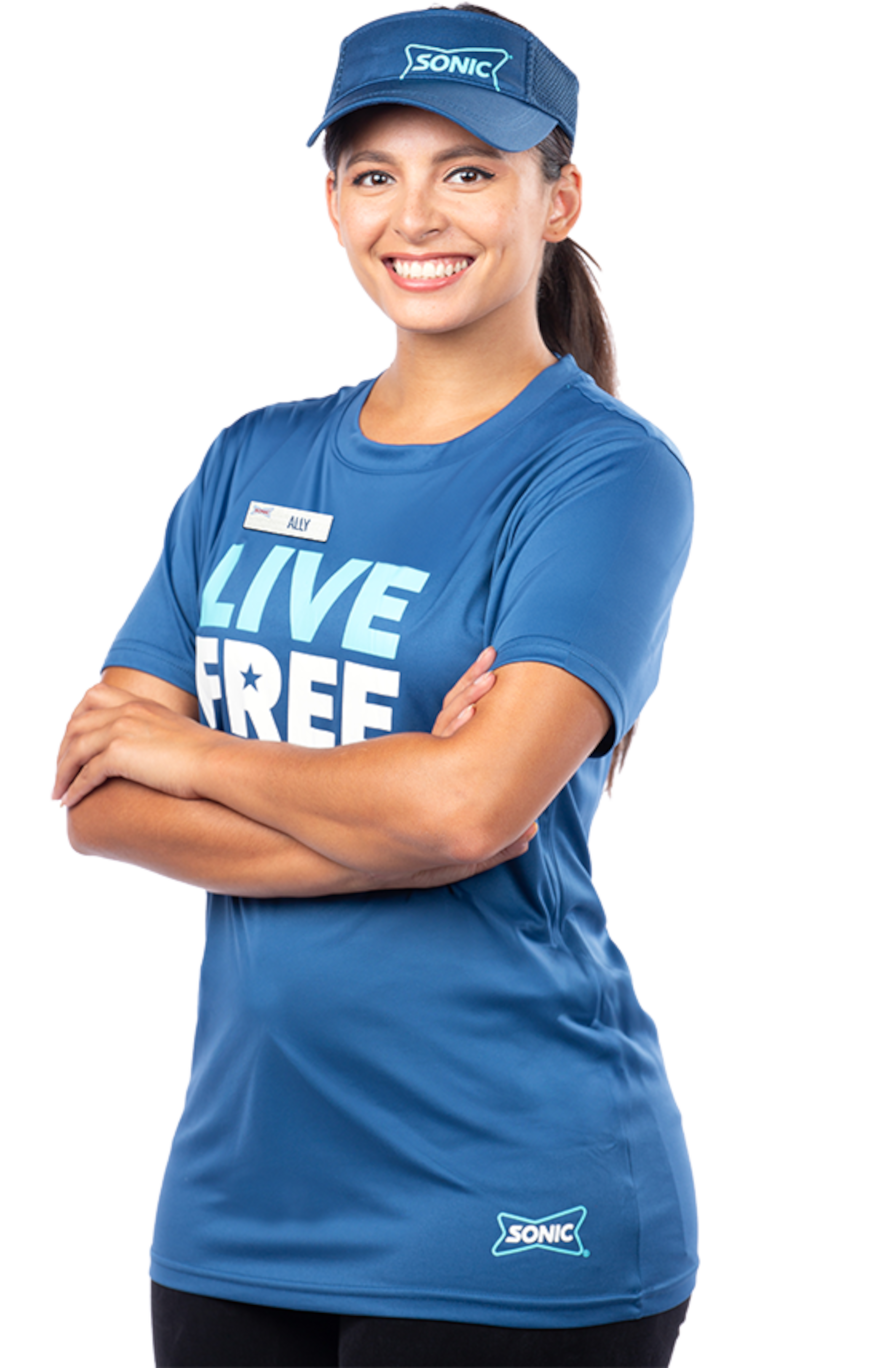 Smiling employee in a Sonic 'Live Free' shirt with arms crossed