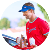 Sonic carhop delivering drinks and food to a customer