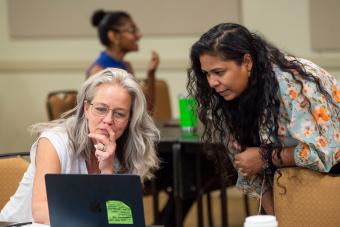 Advisory council board members looking at a laptop screen