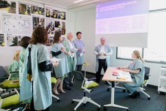 students in scrubs in a M.A. in Design focused on Health partnership course with Dell Medical School at UT Austin