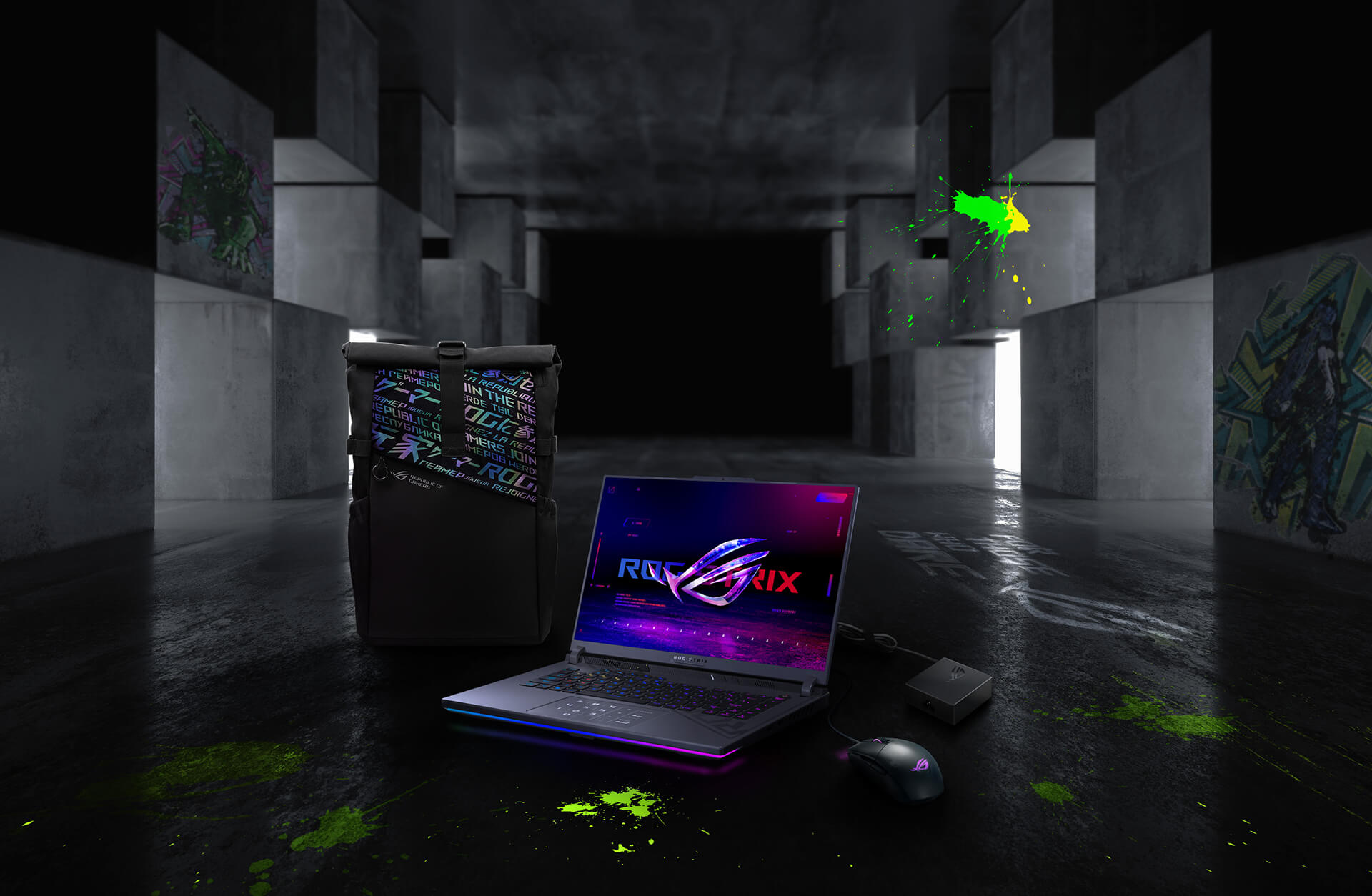 In an underground big space, from left to right; an ROG backpack, G16, ROG Strix Gladius III mouse, and 100W adapter.