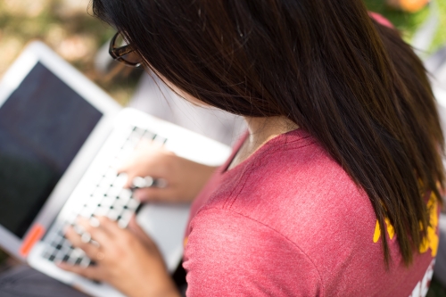 Student typing on laptop