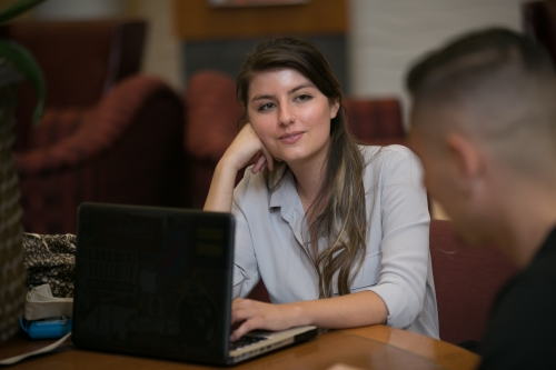 Student listening with laptop open