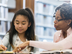 Teacher helping student