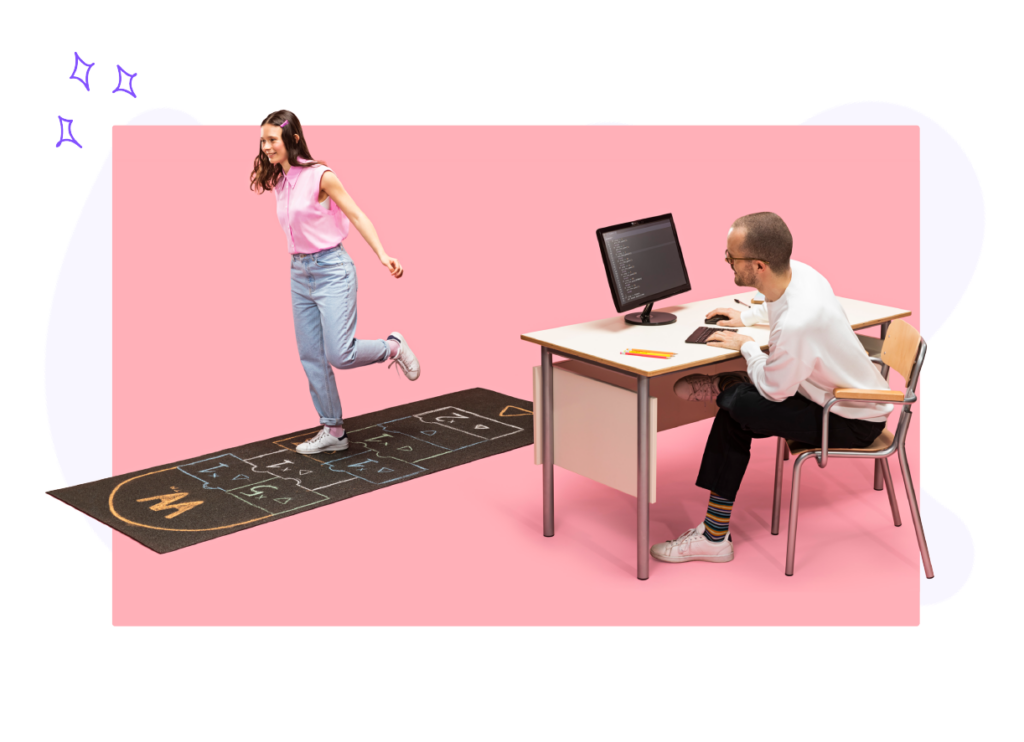 A student playing Hopscotch happily while a male teacher stares at her enthusiastically behind a desk while typing on a computer keyboard