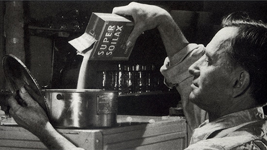 Ecolab Technician pouring Ecolab product into equipment