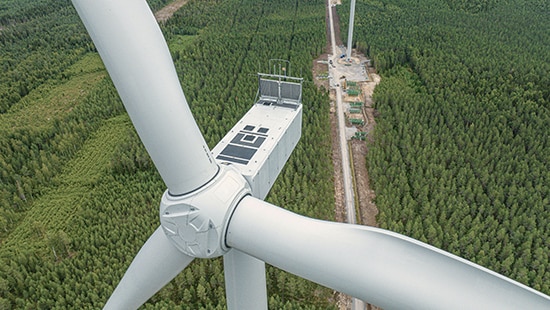 Large windmill photographed from above a field