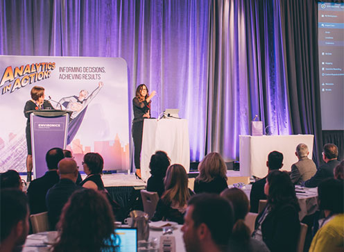 Two speakers at two podiums addressing an audience