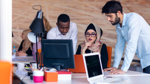 workers collaborate around computers