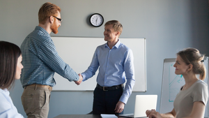 manager shaking hands with a team member