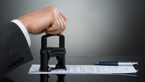 business person stamping a document