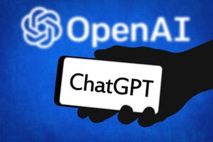 an image of someone holding a phone with a screen that says "ChatGPT" in front of something that says "OpenAI"