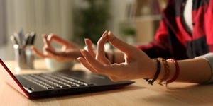 Close up of student girl hands stress relieving doing yoga pose at night at home