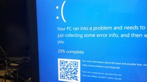 Blue computer screen with white words saying that the computer has a problem