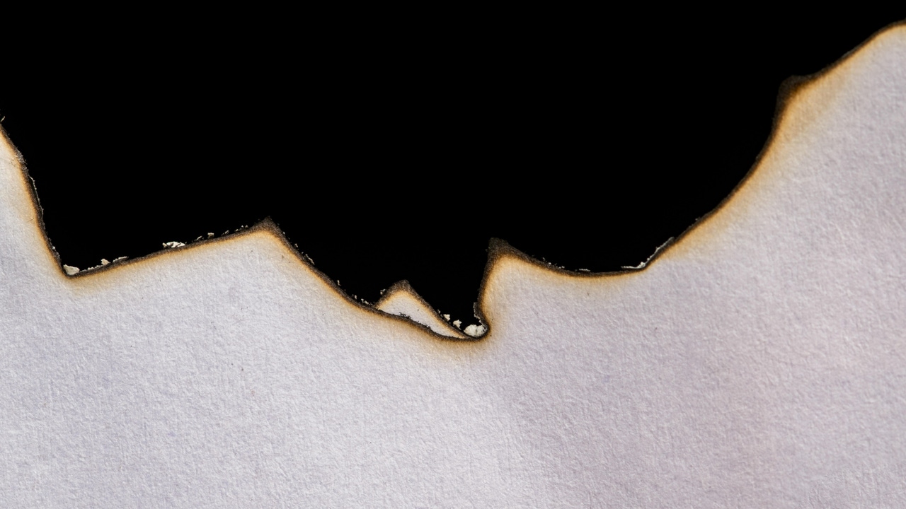 A burning piece of white paper