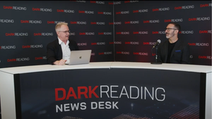 Two people talking at a news desk against a dark backdrop with "Dark Reading" written on it.