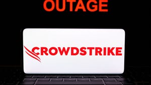 CrowdStrike logo seen on screen of smartphone and the word OUTAGE seen behind it 