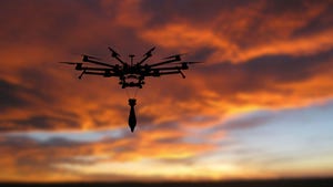 Military drone with a bomb at sunset