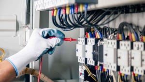 a gloved hand plugging probes into sensor panel.