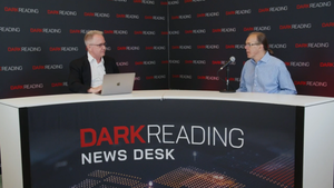 Two people talking at a news desk against a dark backdrop with "Dark Reading" written on it.