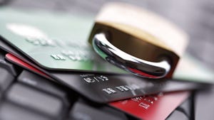 Padlock atop credit cards on a keyboard