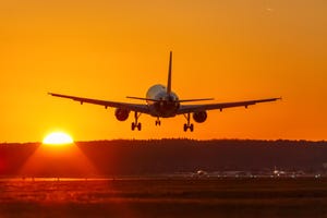 Plane taking off at sunset