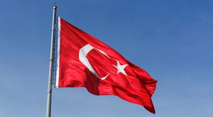 A Turkish flag waving on a pole