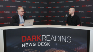 Two people talking at a news desk against a dark backdrop with "Dark Reading" written on it.