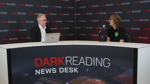 Two people talking at a news desk against a dark backdrop with "Dark Reading" written on it.