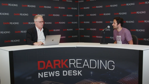 Two people talking at a news desk against a dark backdrop with "Dark Reading" written on it.