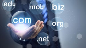 An unseen man in a suit holding up his hand holding a glowing orb that says ".com" Surrounding it are other orbs holding domain names