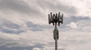 5G cellphone tower against a cloudy sky